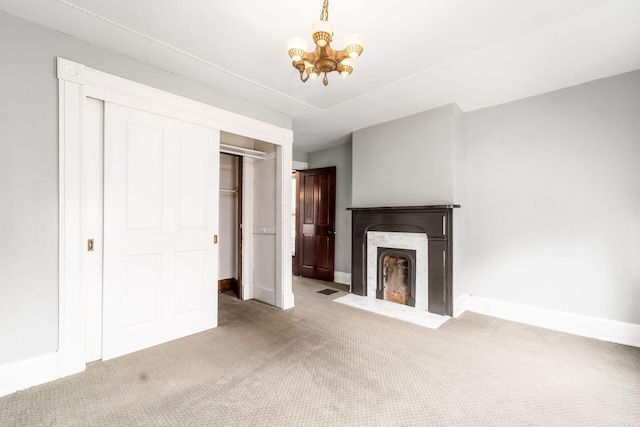 unfurnished living room with carpet and a chandelier