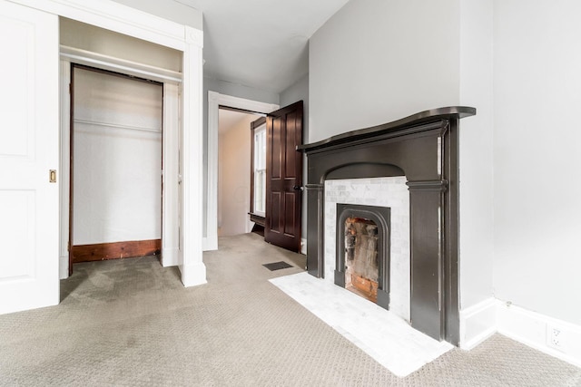 unfurnished living room with light colored carpet