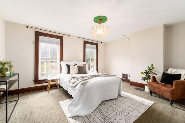 bedroom featuring carpet floors and an inviting chandelier