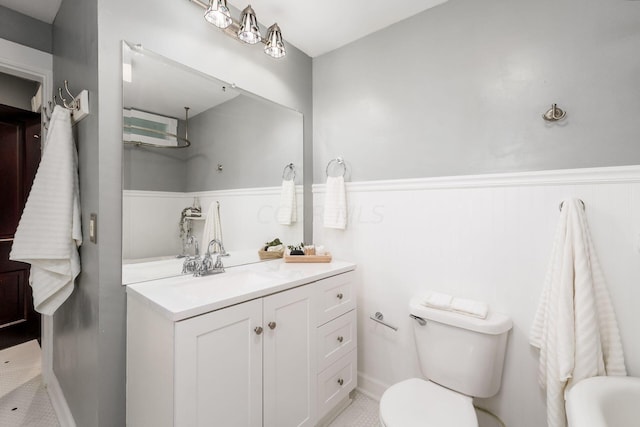 bathroom featuring tile patterned flooring, vanity, and toilet