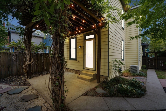 view of exterior entry featuring central AC unit