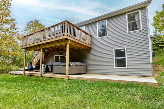 back of house with a lawn, cooling unit, a hot tub, and a deck