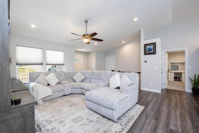 living room with ceiling fan, dark wood-type flooring, and vaulted ceiling