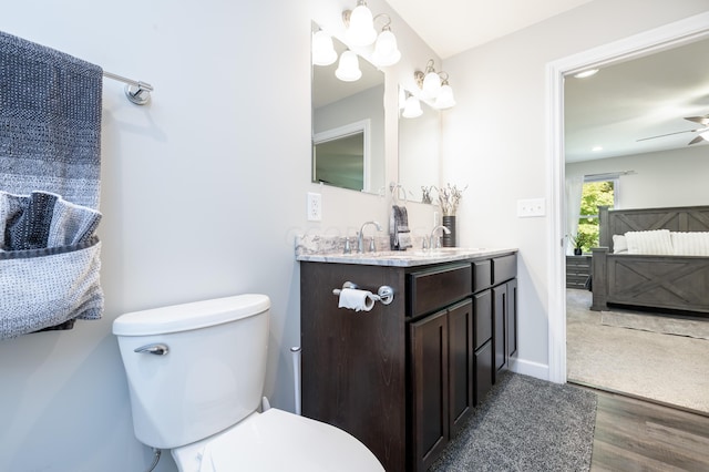 bathroom featuring hardwood / wood-style flooring, vanity, ceiling fan, and toilet