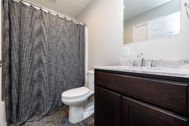 bathroom with hardwood / wood-style floors, vanity, toilet, and curtained shower