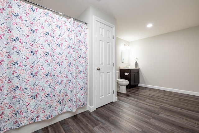 bathroom featuring hardwood / wood-style floors, vanity, and toilet