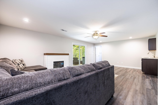 living room with ceiling fan and hardwood / wood-style flooring