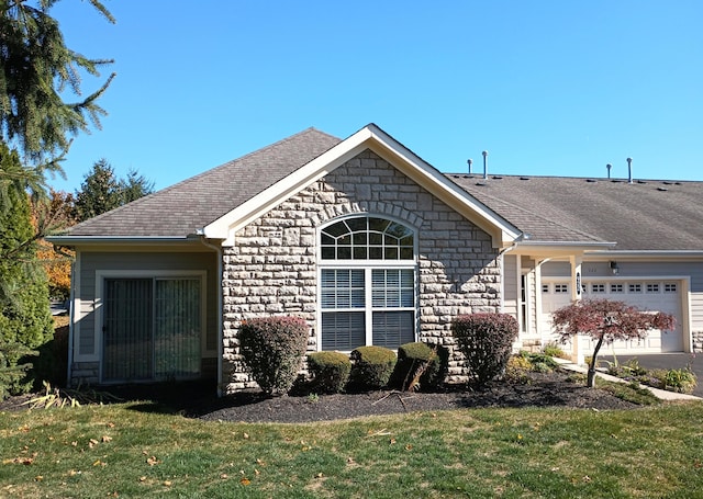 ranch-style house featuring a front lawn and a garage