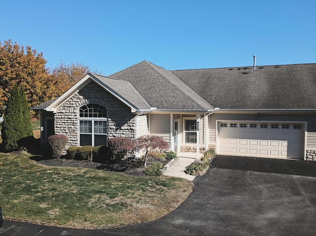 ranch-style home with a front yard and a garage