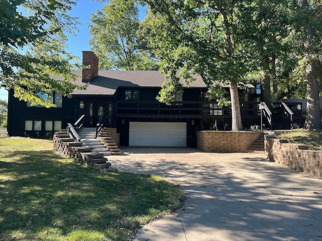 view of front of house with a garage and a wooden deck