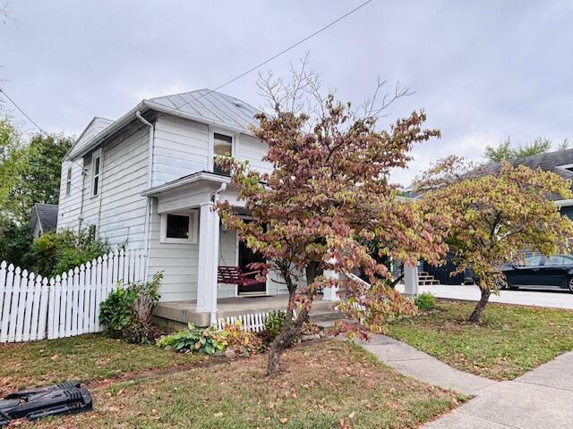 view of side of property with a yard and a porch