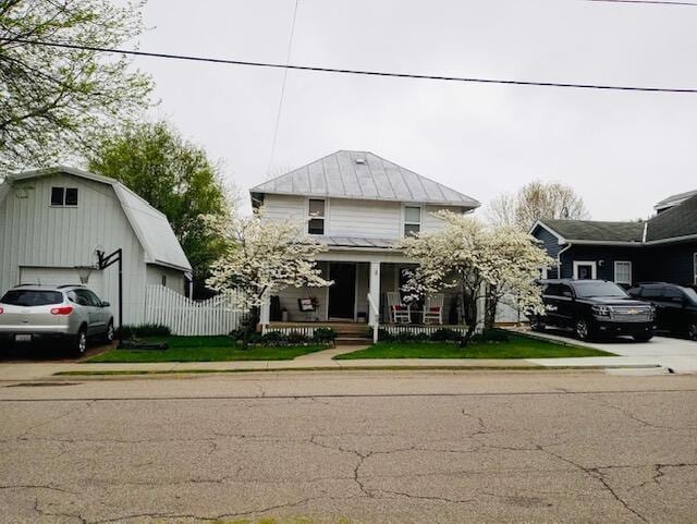 view of front of home featuring covered porch and a garage