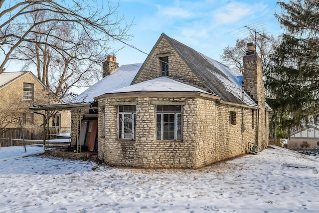 view of snow covered back of property