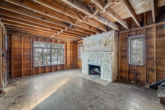 unfurnished living room with a stone fireplace