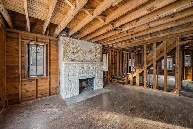 unfurnished living room with a stone fireplace