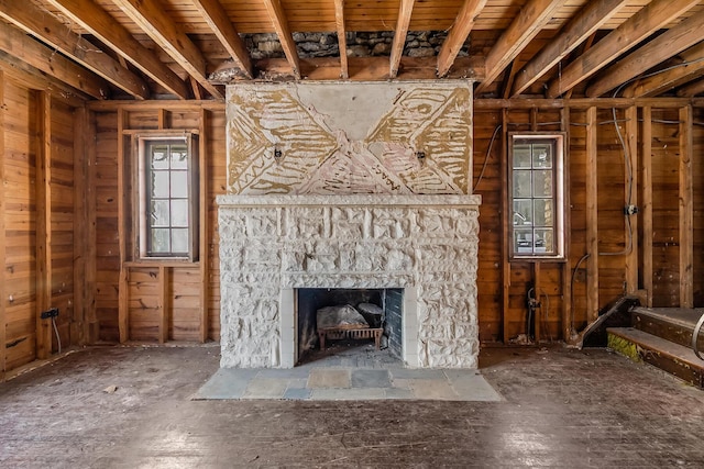 unfurnished living room featuring a stone fireplace