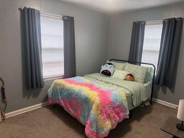 carpeted bedroom featuring multiple windows