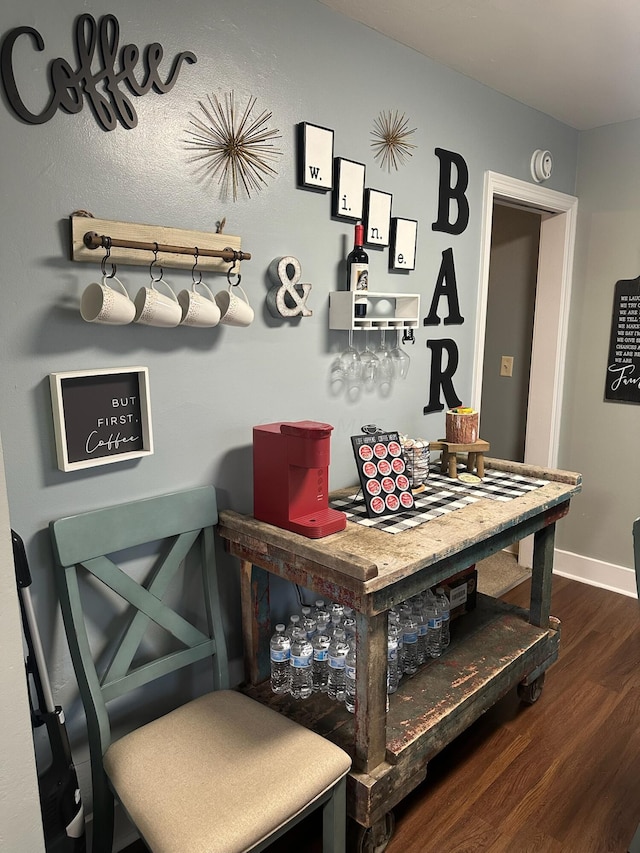 bar with dark hardwood / wood-style flooring