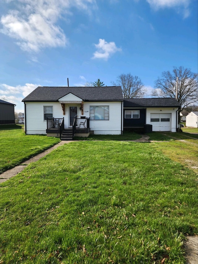 single story home featuring a wooden deck, a front lawn, and a garage