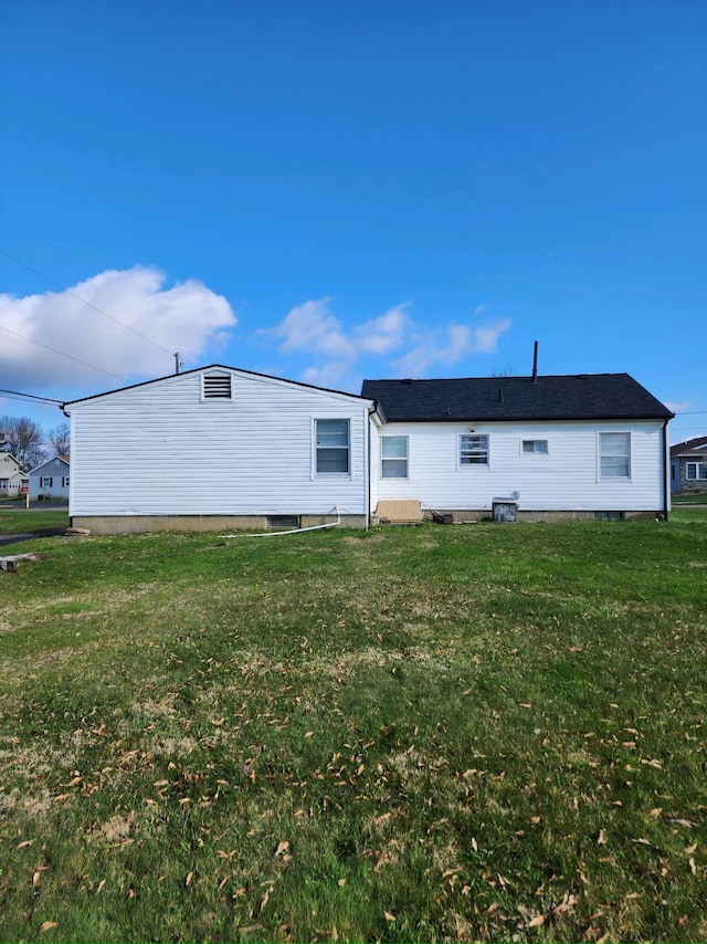 rear view of property with a yard