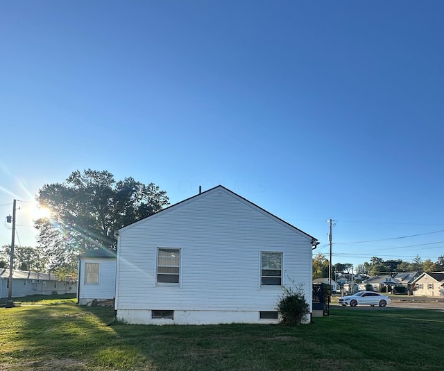 view of side of property with a lawn