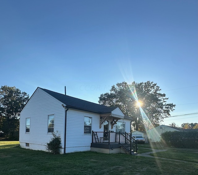 rear view of property featuring a yard