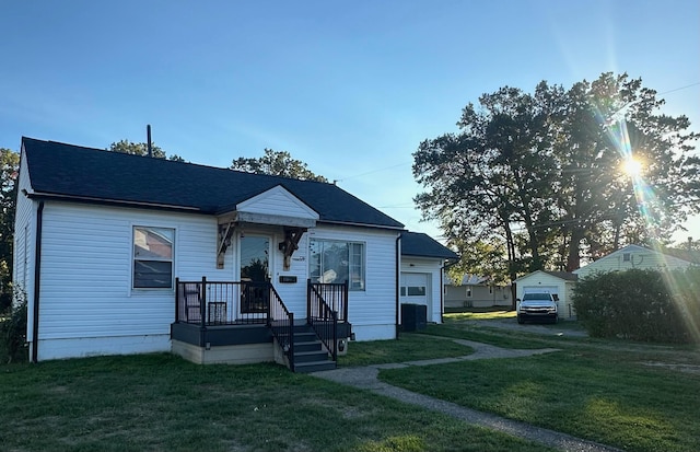 bungalow with a garage and a front lawn