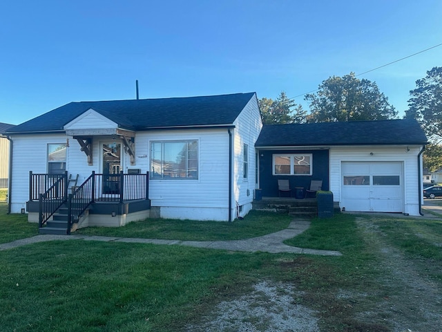 view of front of property with a front yard and a garage