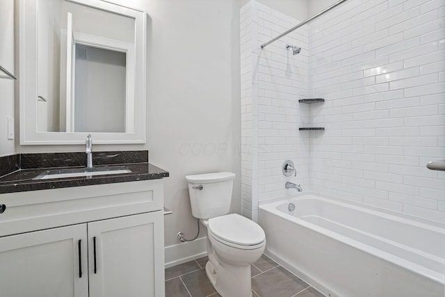 full bathroom with toilet, tiled shower / bath, tile patterned floors, and vanity