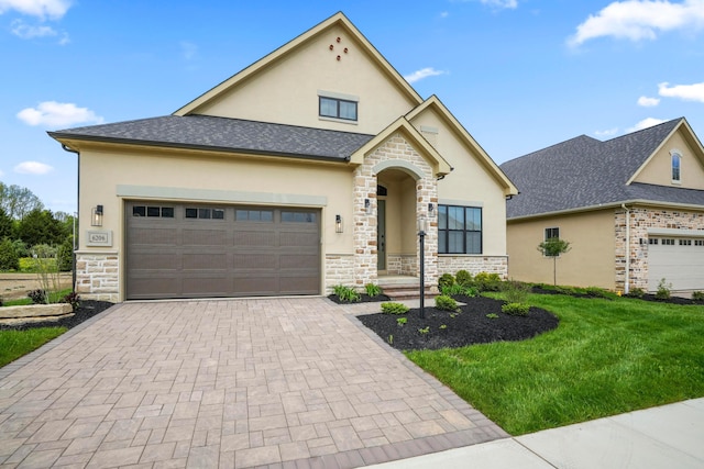 6206 Garden Loop, Westerville, OH 43082 - view of front facade with an attached garage, stucco siding, decorative driveway, and stone siding