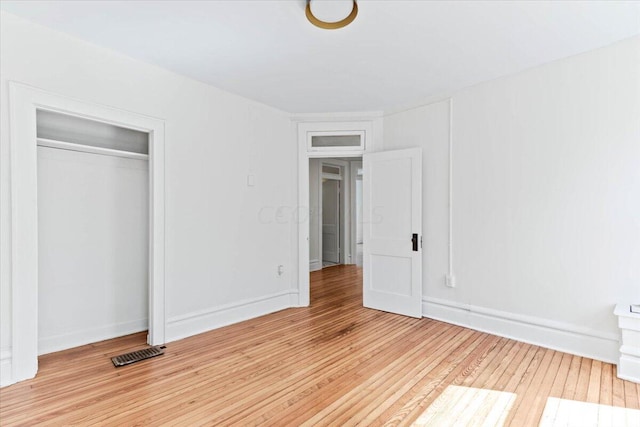 unfurnished bedroom with a closet and light hardwood / wood-style flooring