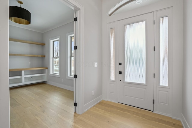 foyer entrance with light hardwood / wood-style floors