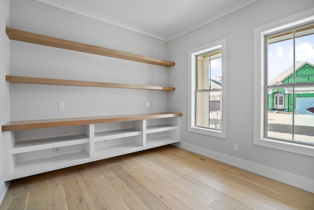 empty room featuring light hardwood / wood-style floors and ornamental molding