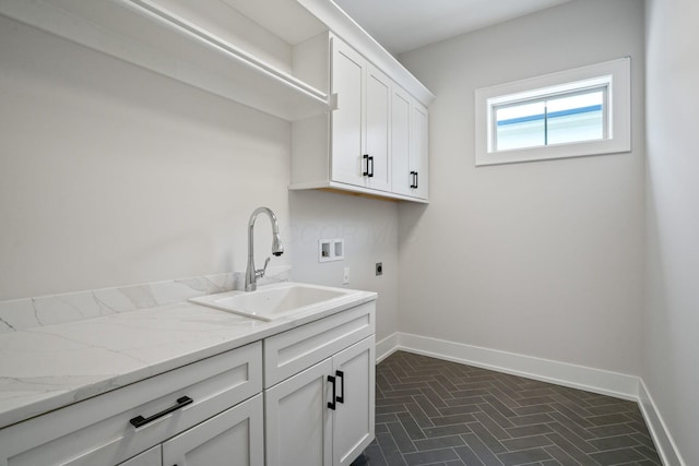 clothes washing area featuring hookup for an electric dryer, cabinets, sink, and hookup for a washing machine