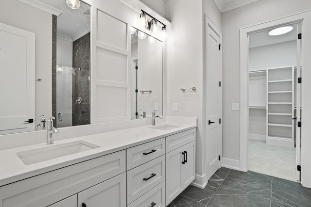 bathroom featuring vanity, an enclosed shower, and ornamental molding