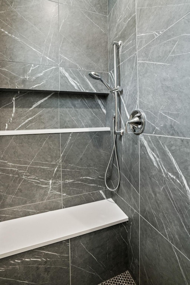 bathroom with a tile shower