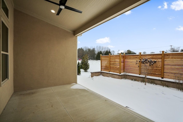 snow covered patio featuring ceiling fan