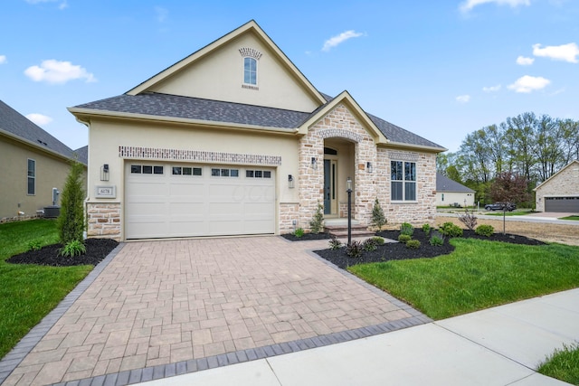 6192 Garden Loop, Westerville, OH 43082 - view of front facade featuring stone siding, stucco siding, decorative driveway, and a front lawn