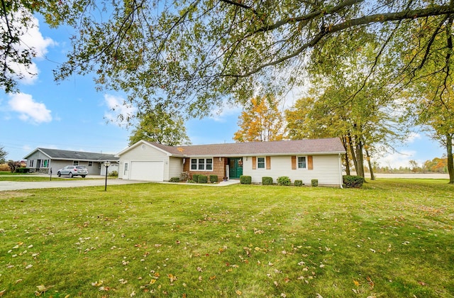 ranch-style house featuring a front yard and a garage