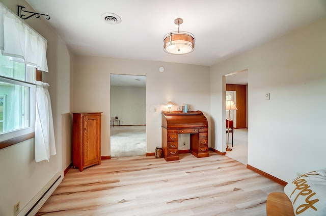 interior space with light hardwood / wood-style flooring and a baseboard radiator