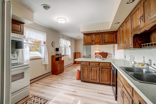 kitchen with a baseboard radiator, black dishwasher, sink, kitchen peninsula, and electric stove