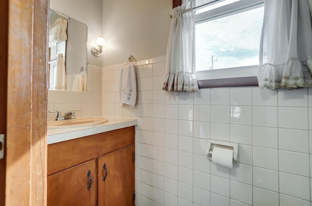 bathroom with vanity and tile walls