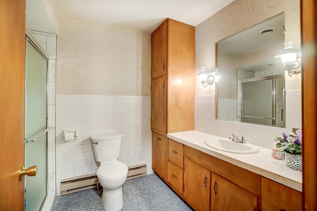 bathroom featuring a baseboard radiator, vanity, an enclosed shower, and tile walls