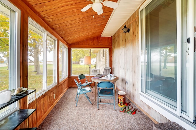 sunroom / solarium featuring lofted ceiling, wooden ceiling, and ceiling fan