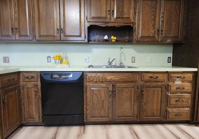 kitchen featuring dark brown cabinetry, sink, light hardwood / wood-style floors, and dishwasher