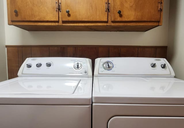 laundry room with cabinets and washer and dryer