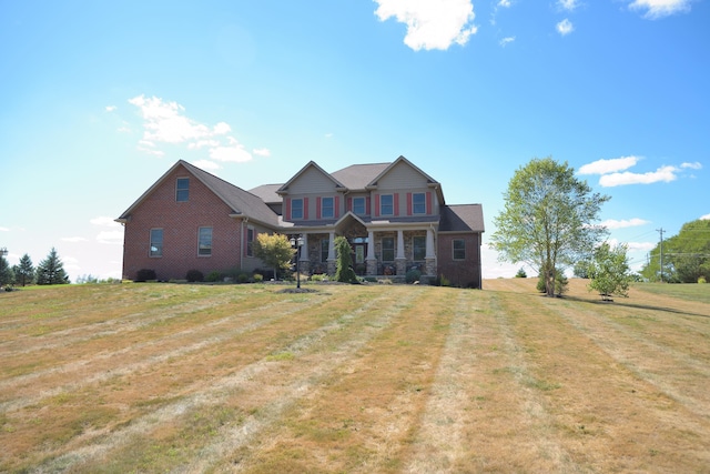 craftsman-style home with a front lawn and covered porch