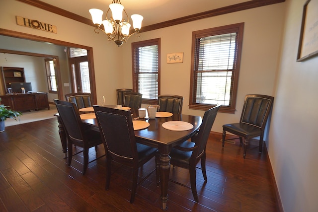 dining room with ornamental molding, dark wood-type flooring, and an inviting chandelier