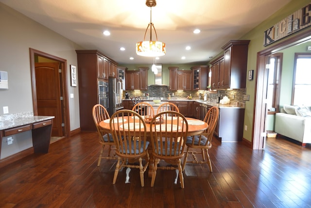 dining space featuring dark hardwood / wood-style flooring and sink