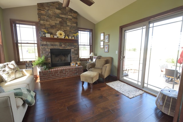 living room featuring vaulted ceiling with beams, ceiling fan, dark hardwood / wood-style flooring, and a fireplace